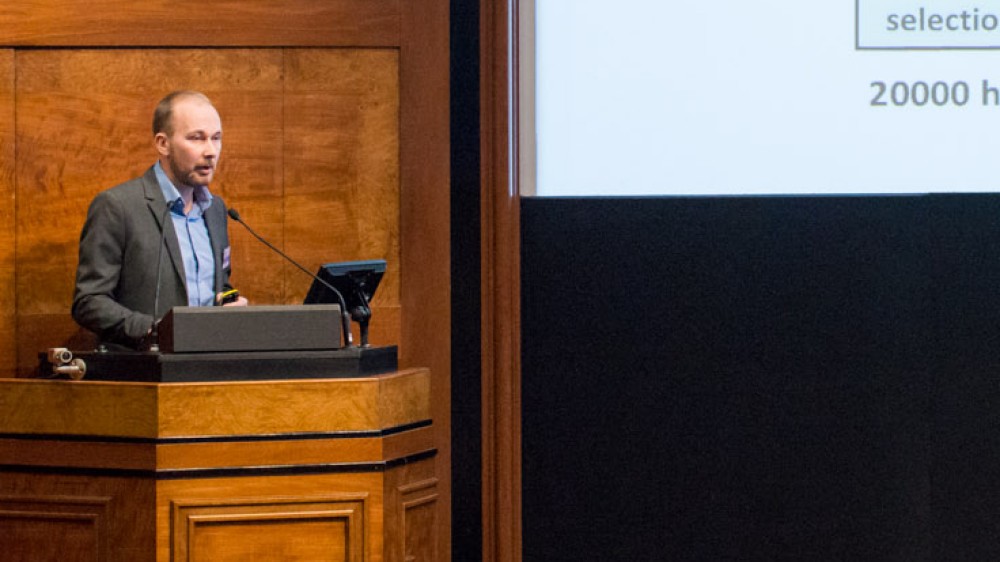 A researcher presents his work at a conference